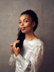 Emma Dabiri in white dress, credit Stuart Simpson, make up Zoe Taylor